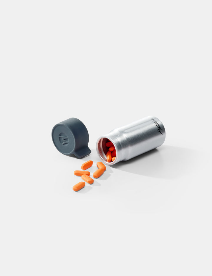 Matador Waterproof Travel Canister - 40ml - silver and gray container with orange pills on a white background