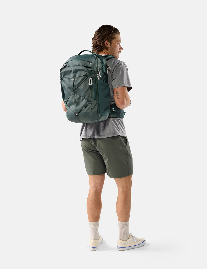 Matador 35L Global Travel Pack in Juniper - person wearing a green backpack on a white background
