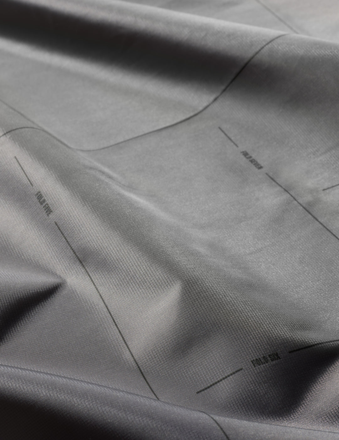 Matador Pocket Blanket™ 4.0 - 160 x 110cm in Black - close-up of gray fabric with subtle texture
