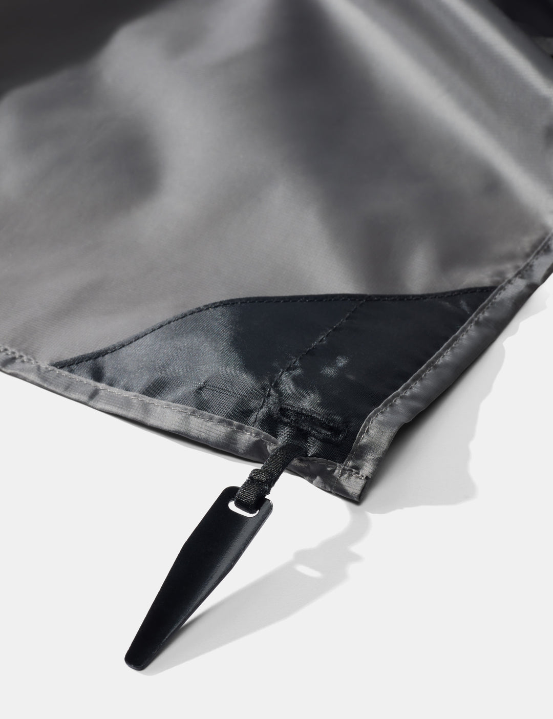 Matador Pocket Blanket™ 4.0 - 160 x 110cm in Black - close-up of pocket blanket corner stake on a white background