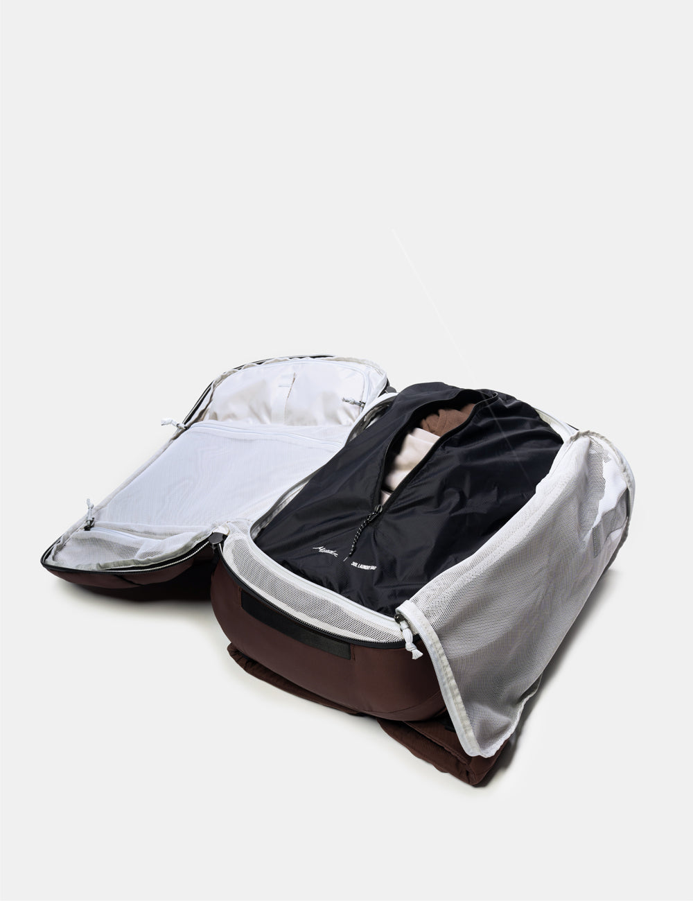 Matador Packable Laundry Bag - open backpack with dirty clothes on a light gray background