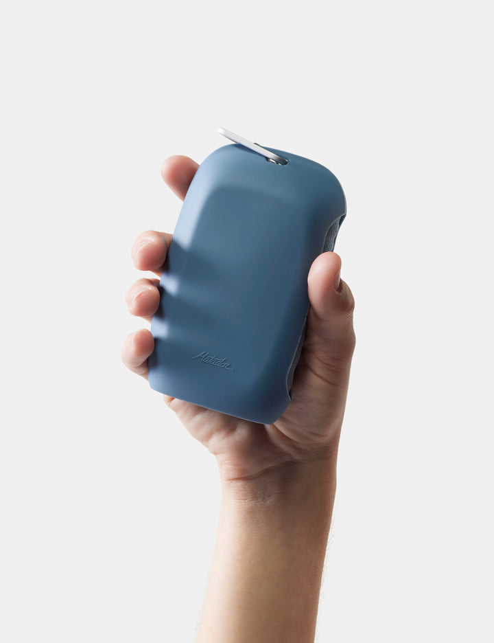 Matador NanoDry Towel - Large 132 x 60cm in Blue - hand holding slate nanodry case against a white background