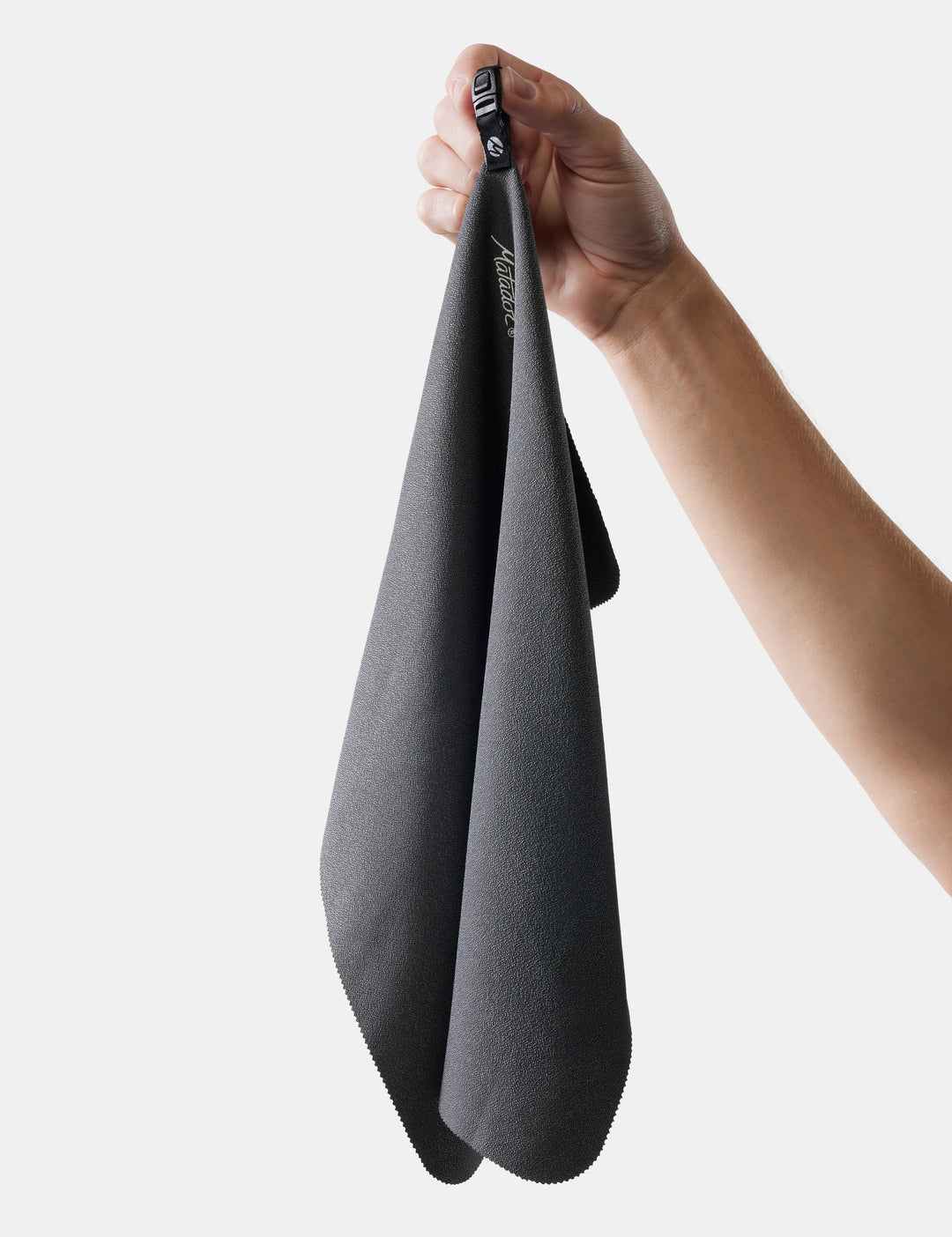 Matador NanoDry Towel - Small 39 x 39cm in Charcoal - person holding a gray towel with a brand logo on a white background