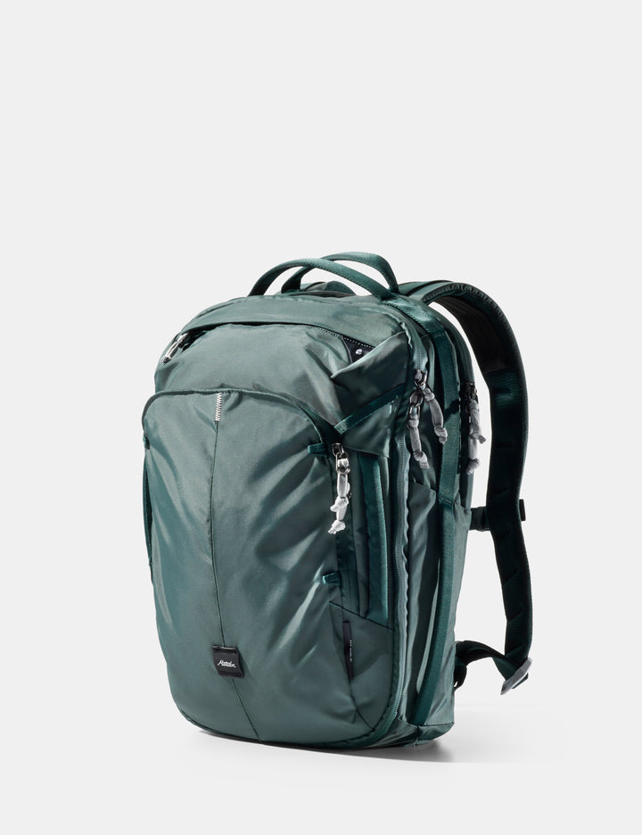 Matador 18L Personal Item Travel Pack in Juniper - green backpack on a light gray background