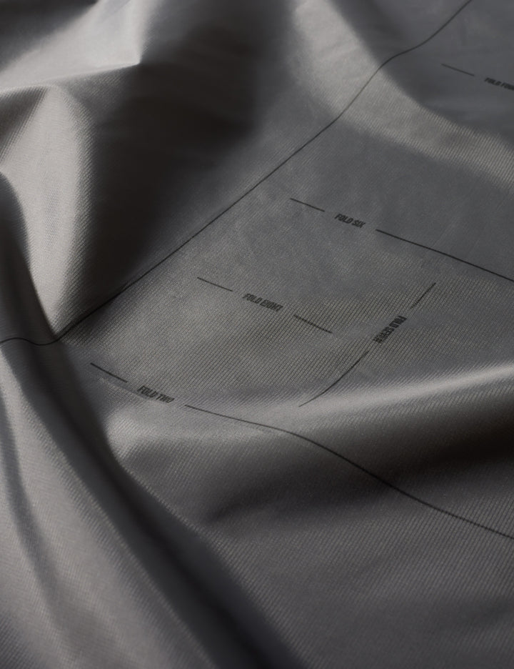 Matador Mini Pocket Blanket™ 4.0 - 110 x 70cm in Ghost Grey - close-up of gray fabric with subtle texture and folds