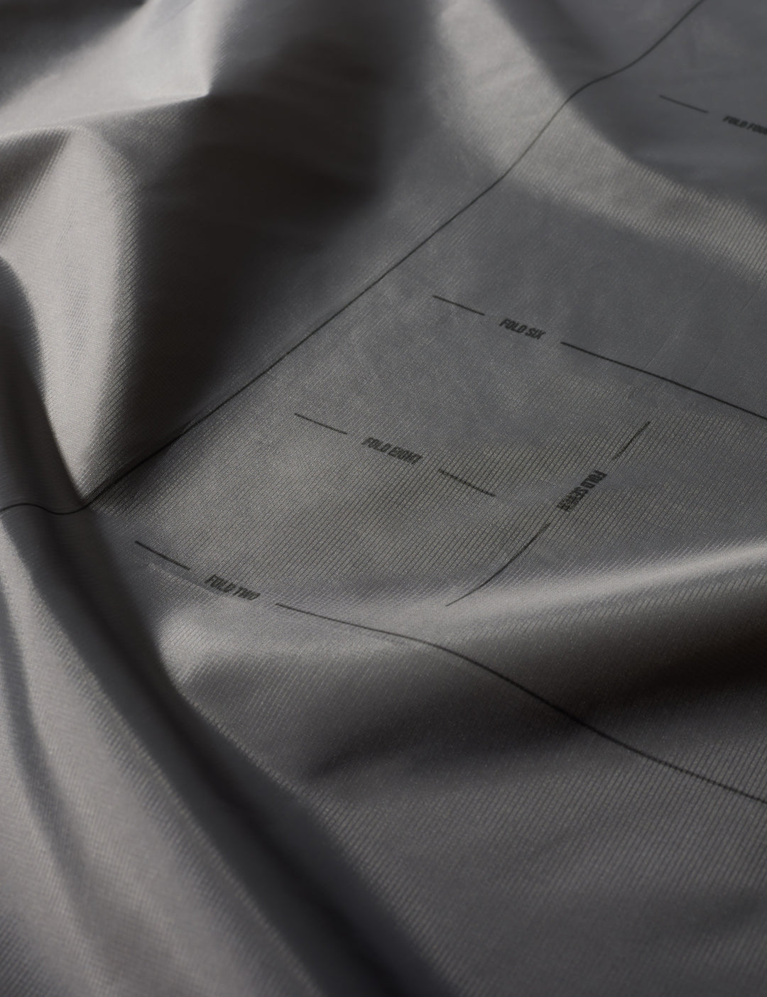 Matador Mini Pocket Blanket™ 4.0 - 110 x 70cm in Blue - close-up of gray fabric with subtle texture and folds