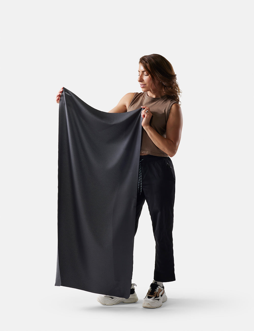 Matador Ultralight Travel Towel - Large 120 x 60cm - woman holding gray fabric against a white background