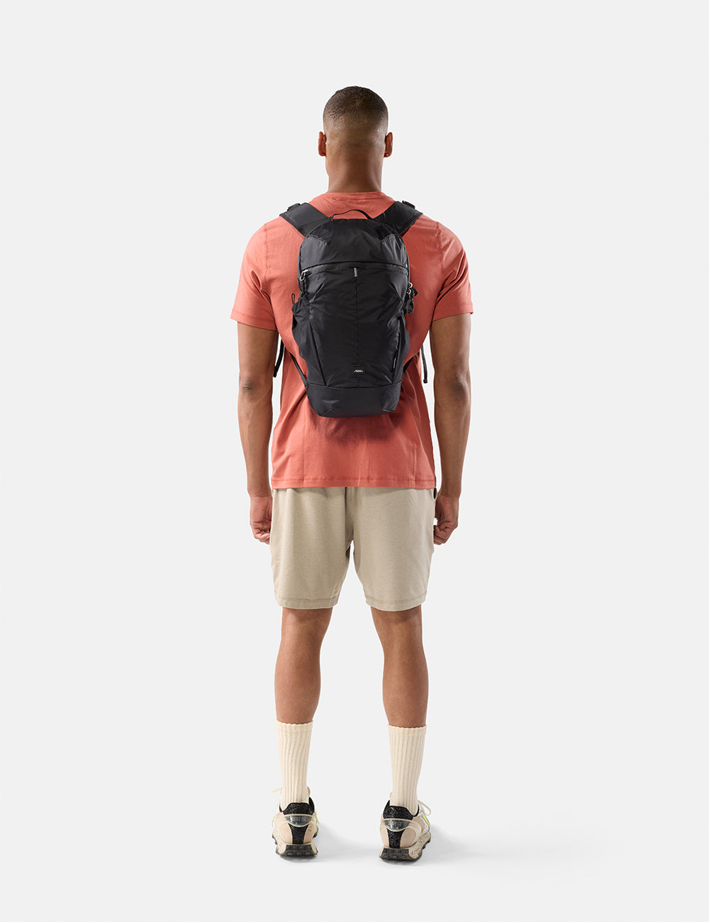 Matador 18L Packable Backpack in Black - man wearing a black backpack on a white background