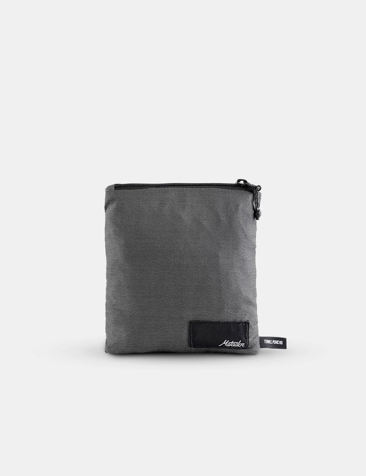 Matador NanoDry™ Packable Towel Poncho in Charcoal - gray pouch with a black zipper on a white background