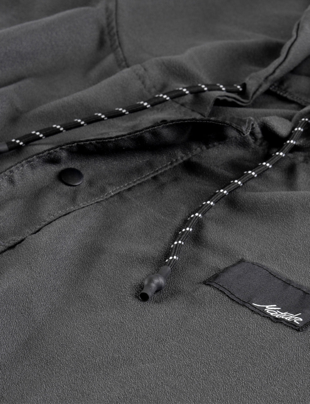 Matador NanoDry™ Packable Towel Poncho in Charcoal - close-up of a dark gray poncho with a brand logo on a black background