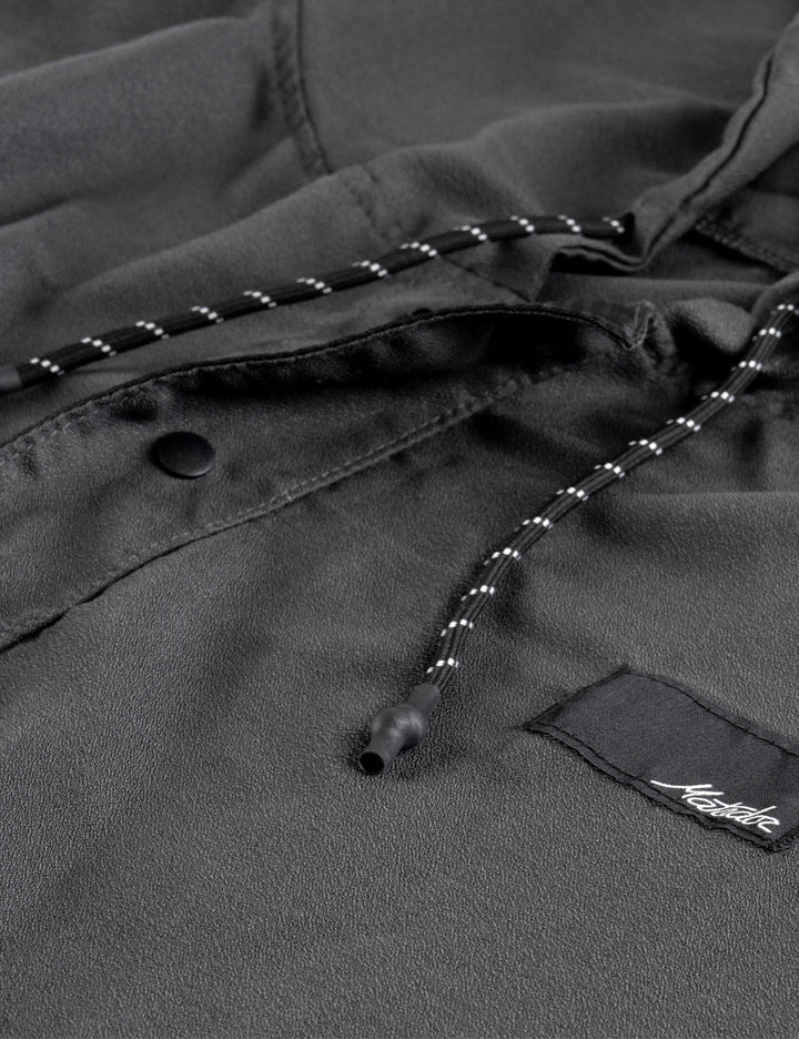 Matador NanoDry™ Packable Towel Poncho in Charcoal - close-up of a dark gray poncho with a brand logo on a black background